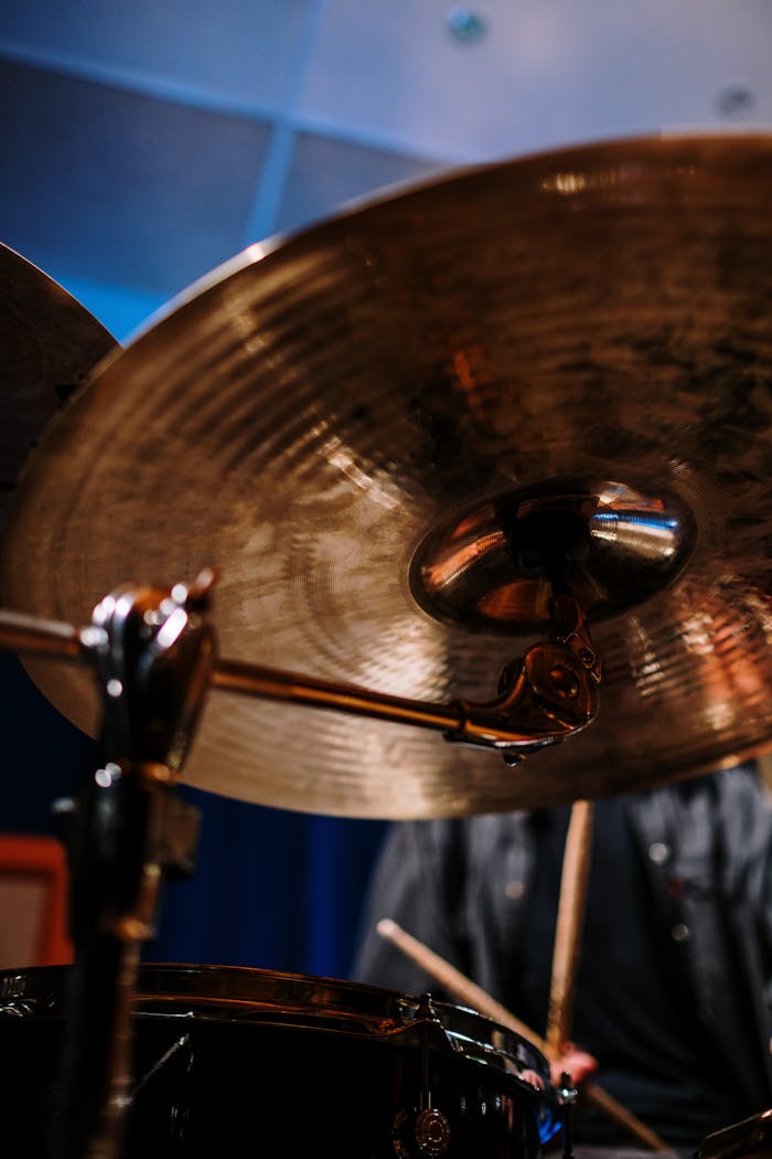 A detailed close-up shot of a cymbal and drum kit, highlighting percussion elements in a studio setting.
